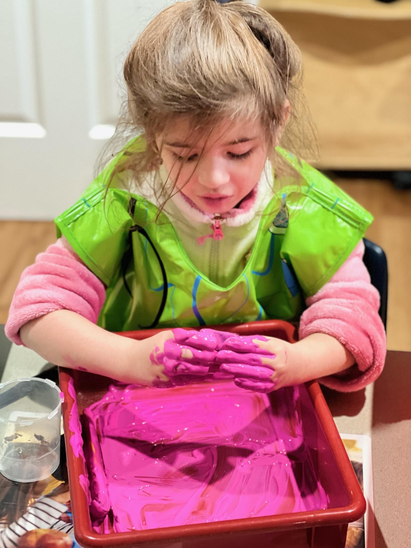 Child working with colorful clay at Yuri’s Childcare