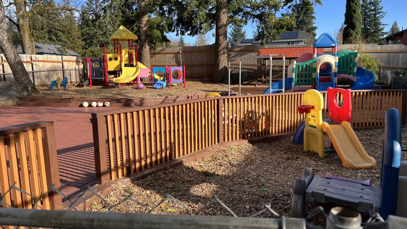 Play area at Yuri’s childcare with many large colorful playsets