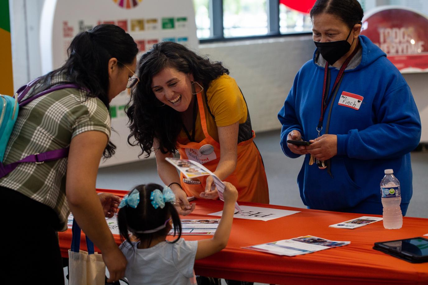 Preschool staff helping family