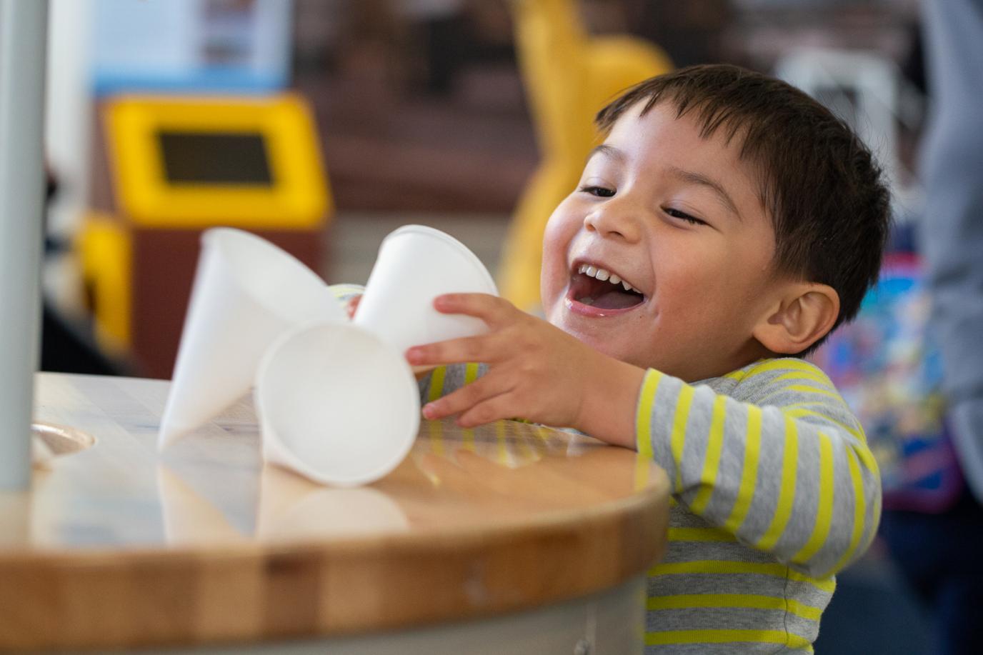 Child having fun with paper cups at OMSI