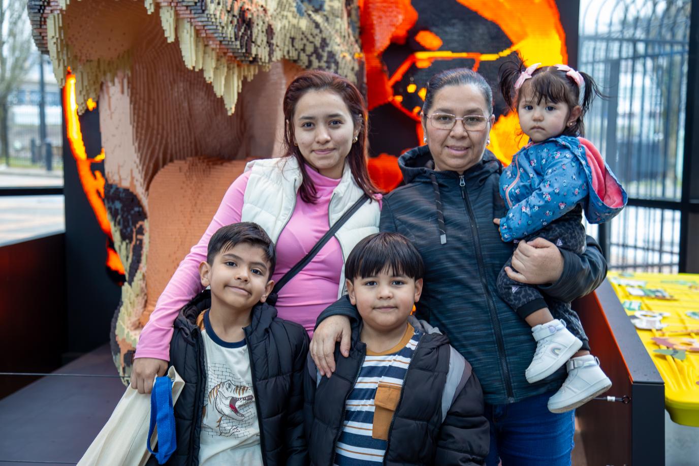 Family at OMSI event in front of Lego dinosaur