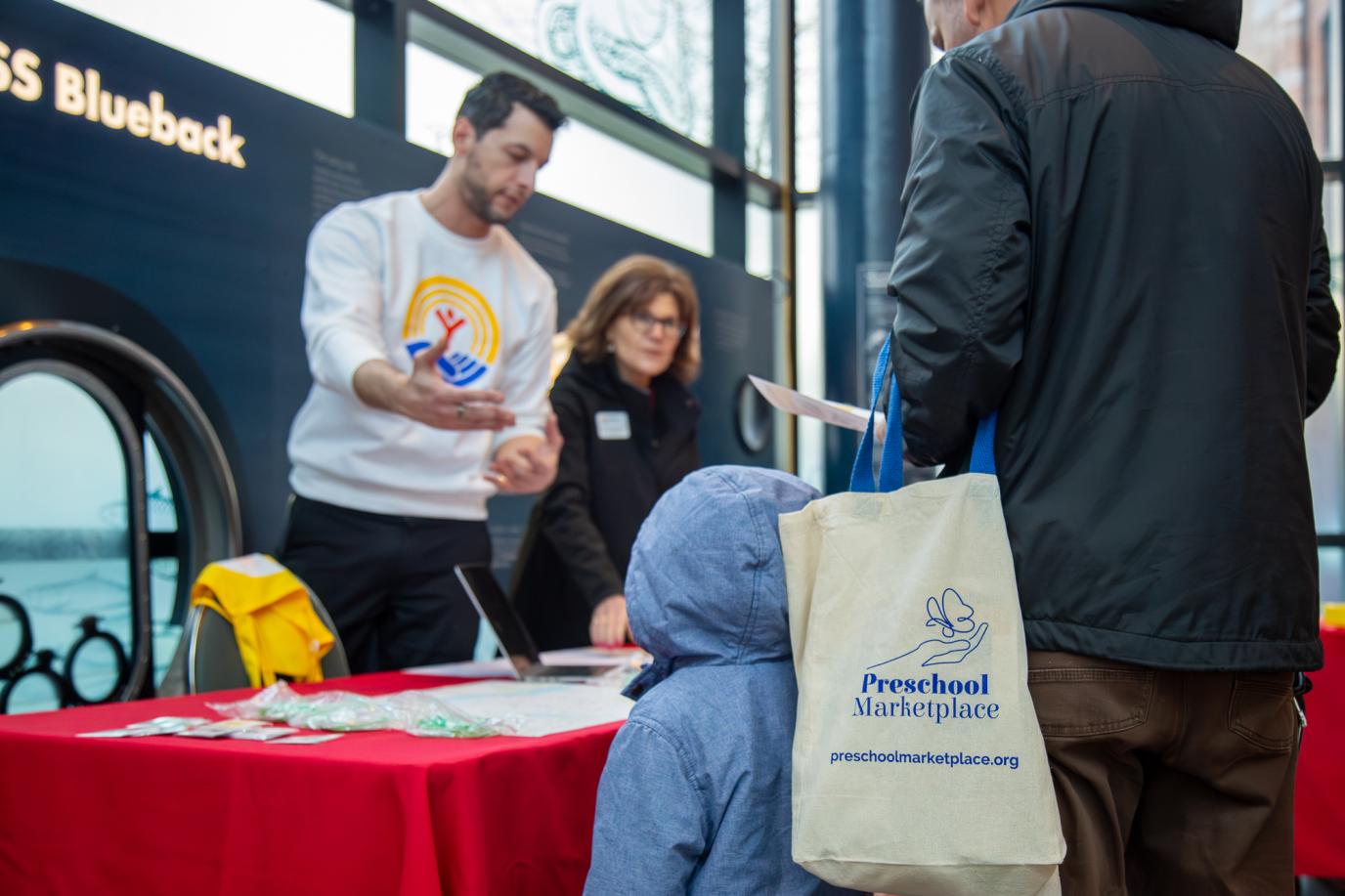 Visitors receiving information at PSM booth at OMSI