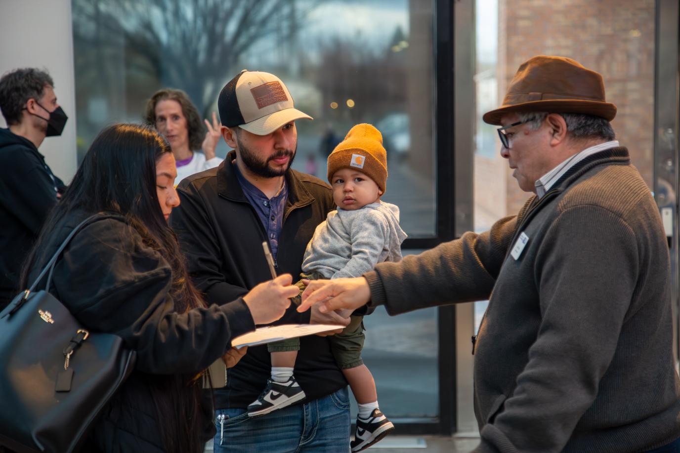 Family filling in information form at OMSI