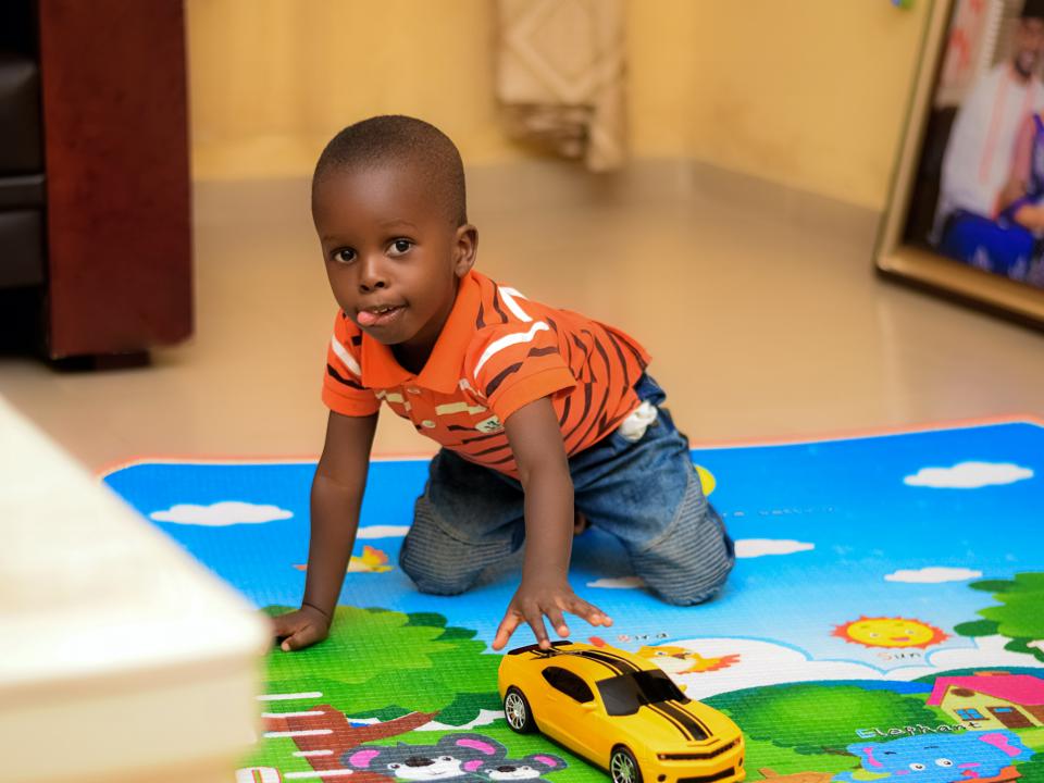 Child with car toy