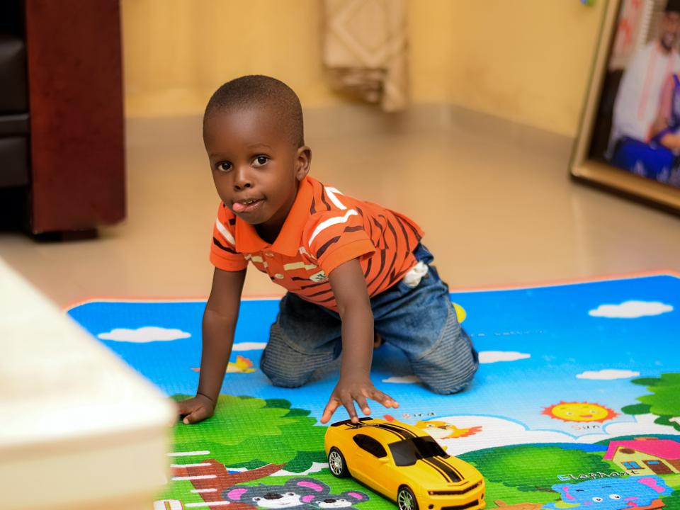 Child with car toy