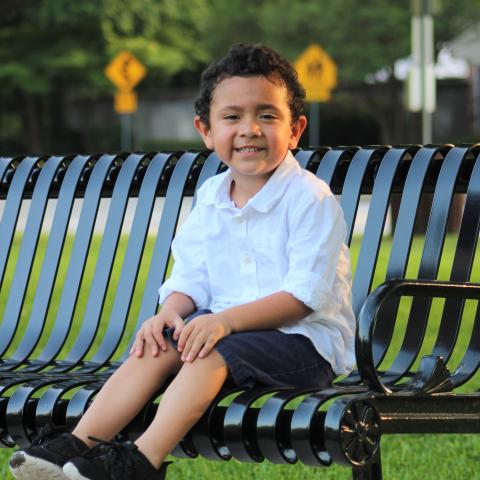 Young boy sitting on a bench